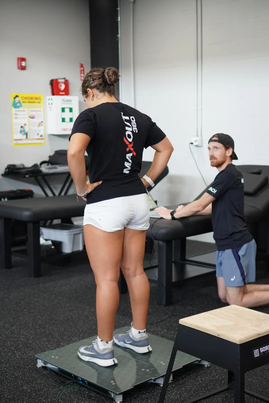 A single-leg balance test on the VALD force plates with a coach watching the data